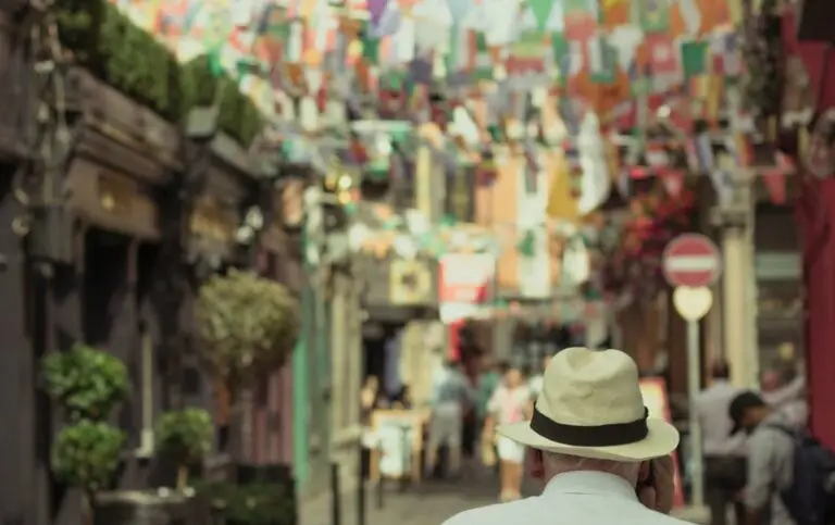 Tourist exploring colorful street with flags and pubs in Dublin, Ireland during a 5 day city tour itinerary