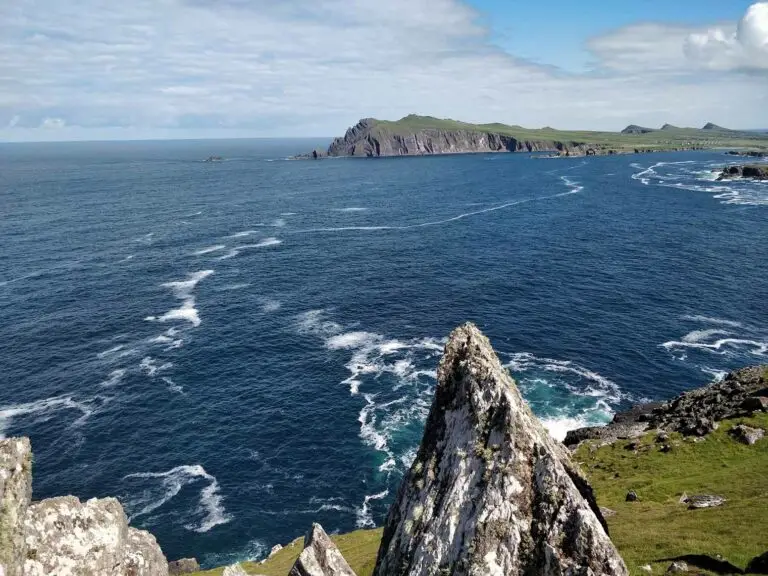 Scenic coastal view of Slea Head Drive with rugged cliffs and Atlantic Ocean waves on the Dingle Peninsula, Ireland