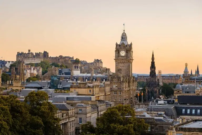 Edinburgh skyline at sunset featuring Edinburgh Castle, Balmoral Clock Tower, and historic city architecture in Scotland