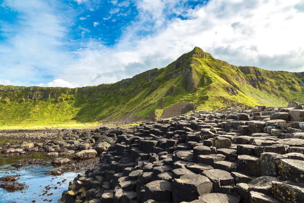 Giant’s Causeway in Northern Ireland featuring unique hexagonal basalt columns and scenic coastal landscape under a bright blue sky