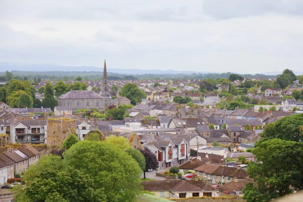 Scenic view of Cashel town in County Tipperary, Ireland featuring historic church spire, stone buildings, and lush green countryside
