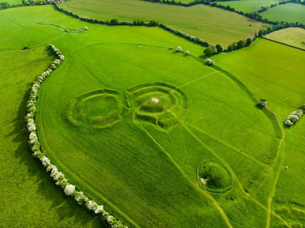 Aerial view of the Hill of Tara in County Meath, Ireland, showcasing ancient earthworks and lush green fields, a popular historical and cultural tourist attraction in Ireland