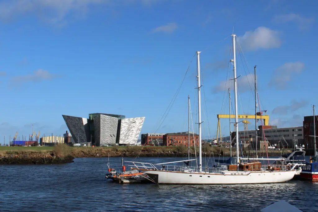 Titanic Belfast museum and marina with sailboats on the River Lagan in Belfast, Northern Ireland under a clear blue sky