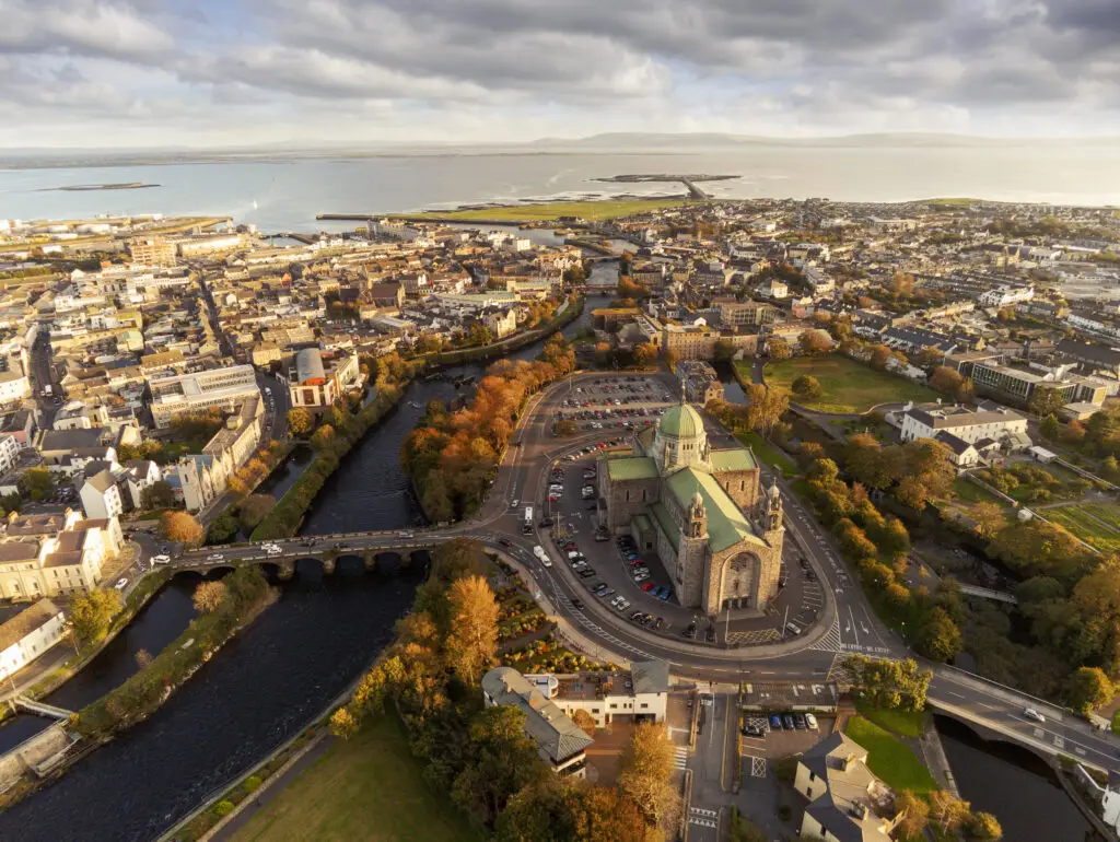 Aerial view of Galway City and Galway Cathedral beside the River Corrib in Galway, Ireland, showcasing historic architecture and scenic coastal landscape