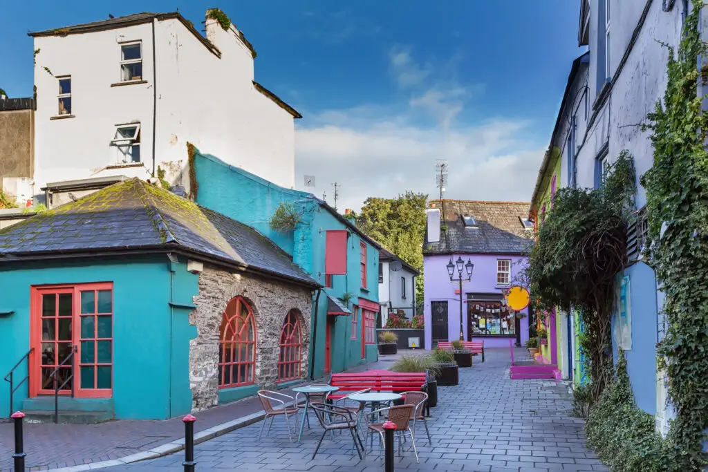 Colorful street with vibrant painted buildings, outdoor café seating, and charming architecture in Kinsale, Ireland