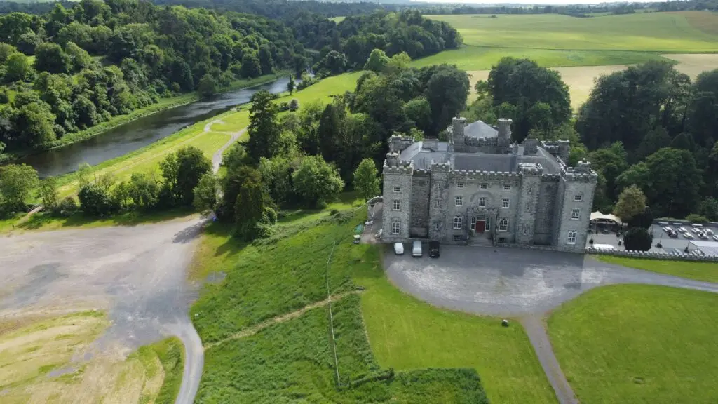 Aerial view of Slane Castle in County Meath, Ireland surrounded by green countryside and the River Boyne, a popular tourist attraction and historic site on luxury Ireland tours