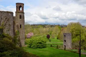 Blarney Castle in County Cork, Ireland surrounded by lush green gardens and scenic countryside, a popular tourist attraction known for its historic stone and beautiful landscapes