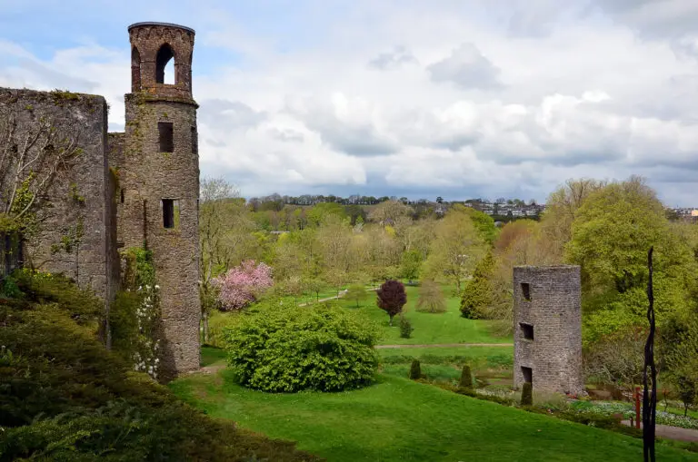 Blarney Castle in County Cork, Ireland surrounded by lush green gardens and scenic countryside, a popular tourist attraction known for its historic stone and beautiful landscapes